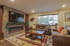 Living Room:  - 1 Large couch, 1 loveseat and tons of seating  - 65” Roku Smart TV  - Streaming services accessible - Cable - Electric fireplace - Custom Metal art - Moose lamp - Moose coasters - Chest with board games inside