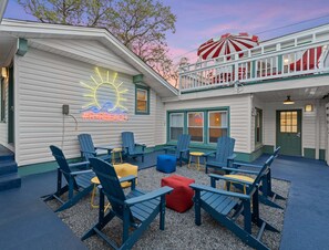 The outdoor common area features comfortable seating, perfect for relaxing or socializing with other guests. This inviting space offers a great spot to enjoy fresh air and unwind in a friendly, communal atmosphere.