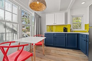 Cozy kitchen setup with comfortable seating for two, perfect for enjoying meals or a morning coffee together.