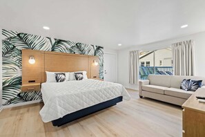 Our King Suite comfortably accommodates up to 4 guests, featuring a luxurious king bed and a sleeper sofa for additional sleeping space. Perfect for a relaxing stay!