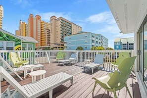 Shared sun deck with glimpses of the ocean. 