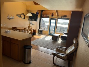 A bright, open living space with large windows invites natural light and stunning outdoor views.