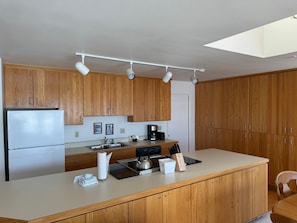 This well-equipped kitchen provides everything you need for preparing meals while enjoying the natural wood accents.