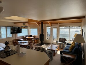 Relax in this bright, open living space with large windows offering sweeping views of the water.