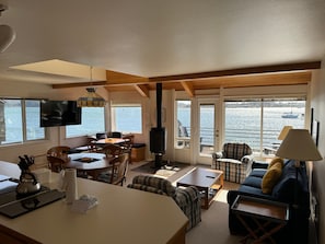 Relax in this bright, open living space with large windows offering sweeping views of the water.