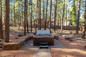 This mountain retreat features a private spa, wraparound deck with outdoor seating and a firepit, plus a game room with a pool table and shuffleboard for endless fun.