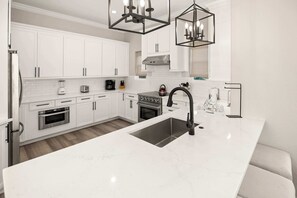 Kitchen: Keurig coffee machine, blender, cooking utensils, tableware