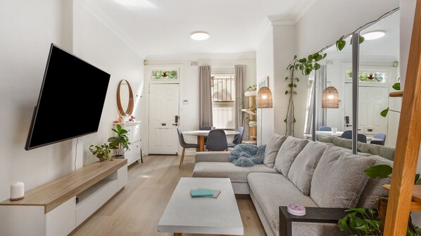 Perfect spot to unwind: comfy seating, a TV, and dining for your convenience.