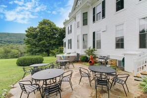 Back patio with dining, hot tub, and gas grill