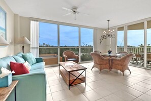 Floor to ceiling windows throughout the living area fill the space with natural light.