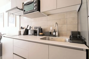 Sleek and modern kitchen with all essentials for a cozy stay in the heart of the city.