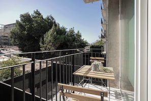 Enjoy a morning coffee on your private balcony with serene views of lush greenery.