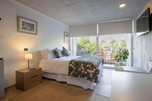 Relax in this cozy studio with a stunning view, featuring a comfortable bed and modern amenities for a perfect stay.