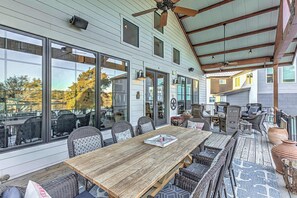 Covered deck off of the main living area with ample seating and incredible lake view