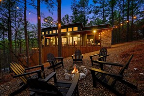 Cozy firepit area with string lights, perfect for evenings under the stars