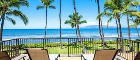 Relax on the private lanai with breathtaking oceanfront views and swaying palm trees.