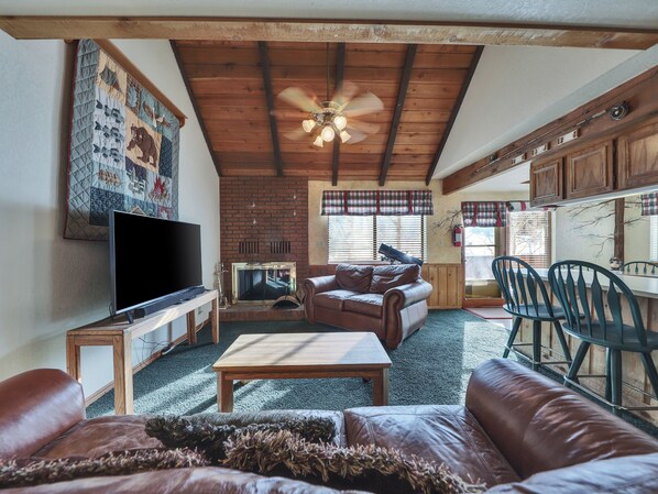 View of the spacious living room featuring comfortable seating, a warm and inviting atmosphere, and plenty of space to relax after a day of adventure.