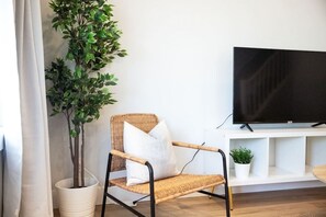The living room’s cozy vibe makes it the perfect spot to relax, with ample seating and a warm ambiance.