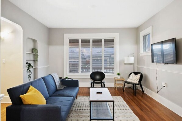 You feel at home as you settle into the living room, where the inviting atmosphere is perfect for lounging or entertaining.