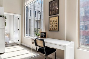 This cozy workspace with warm lighting, and a creative wall display, perfect for productivity.