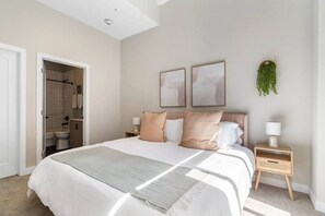 The bedroom’s serene ambiance invites you to relax, with a plush bed that promises a restful night's sleep.