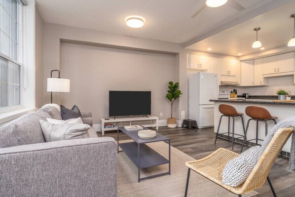 Relax in this warm, inviting space with wooden accents and cozy furnishings. You’ll love unwinding on the plush sofa, enjoying a good book or streaming your favorite shows in a serene atmosphere