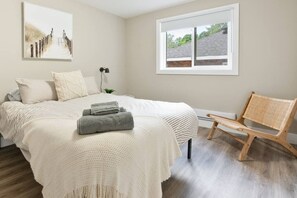The bedroom’s serene ambiance invites you to relax, with a plush bed that promises a restful night's sleep.