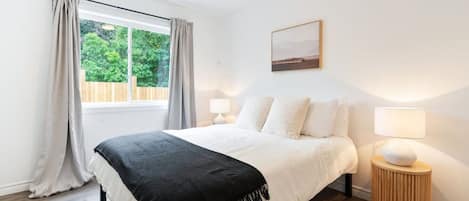 The bedroom’s serene ambiance invites you to relax, with a plush bed that promises a restful night's sleep.
