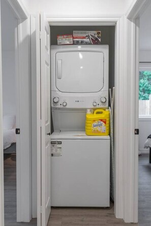 As you step into the laundry room, the modern appliances and ample storage space make it easy to keep things tidy.
