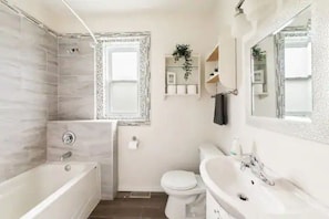 You feel a sense of calm as you enter the bathroom, where the thoughtful design and high-quality materials create a serene environment.