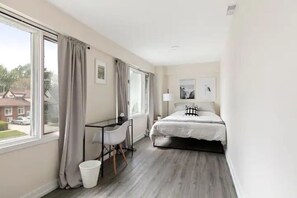 The bedroom’s serene ambiance invites you to relax, with a plush bed that promises a restful night's sleep.