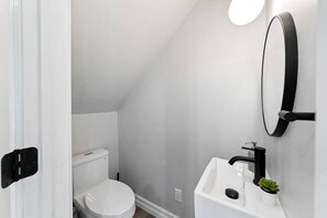 You feel a sense of calm as you enter the bathroom, where the thoughtful design and high-quality materials create a serene environment.