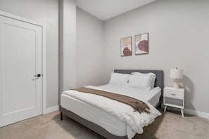 The bedroom offers a luxurious retreat, with a bed that promises restful nights and a room that feels like a private oasis.