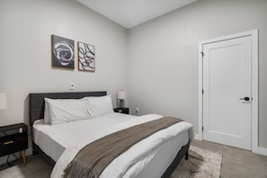 The bedroom’s serene ambiance invites you to relax, with a plush bed that promises a restful night's sleep.