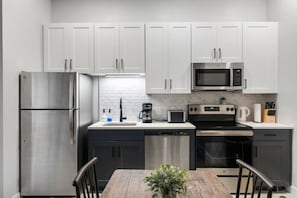As you open the kitchen, you discover an assortment of coffee pods, and sugar, ensuring you have everything you need for a perfect morning or afternoon pick-me-up.