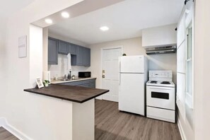 The kitchen’s open layout allows you to move freely as you prepare meals, with everything you need at your fingertips.