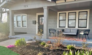 Covered front porch with plenty of seating - perfect spot to enjoy a coffee!