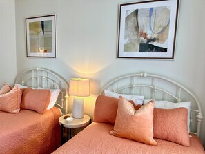 The 2nd bedroom has 2 full beds and balcony access.