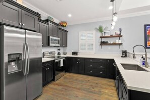 The kitchen is well-stocked with pots, pans, plates and cooking utensils for you to whip up a simple meal