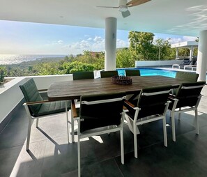 Out door Dinning table for 10 on the Covered terrace over looking pool/Ocean