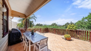 Enjoy outdoor dining with a BBQ in this spacious patio area.