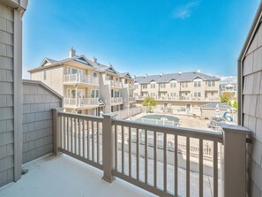 Private balcony offering a serene view of the surrounding neighborhood, perfect for relaxing in the fresh air.