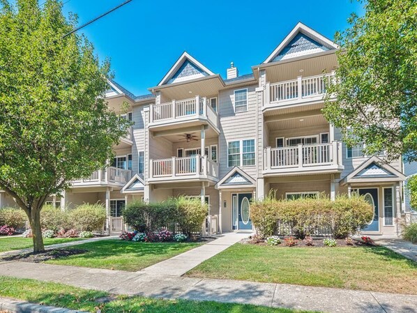 Beautiful multi-level townhouse with charming balconies and lush landscaping, offering plenty of space for your group getaway.