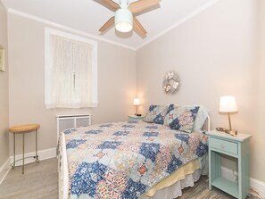 Relax in the cozy bedroom featuring a Queen bed, soft lighting, and charming decor for a peaceful night’s sleep.