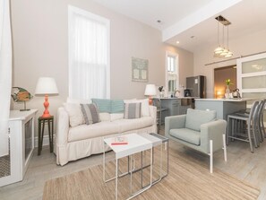 Step into the bright and open living area featuring cozy seating, modern decor, and an inviting atmosphere.