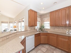 A closer look at the spacious kitchen, featuring modern appliances and a thoughtful layout.