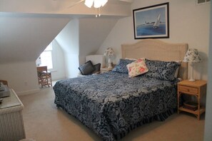 Spacious bedroom with a king-size bed, vaulted ceilings, and cozy decor for a restful night’s sleep.