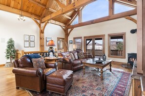 Vaulted Ceiling with Exposed Beams, Gas Stove and Leather Furniture