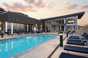 Apex clubhouse with heated pool, hot tub, patio lounge chairs and fit pit