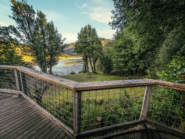 Enjoy a coffee from this wrap-around deck overlooking the Rogue River